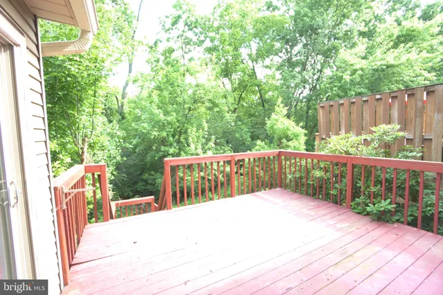 a balcony with wooden floor and fence