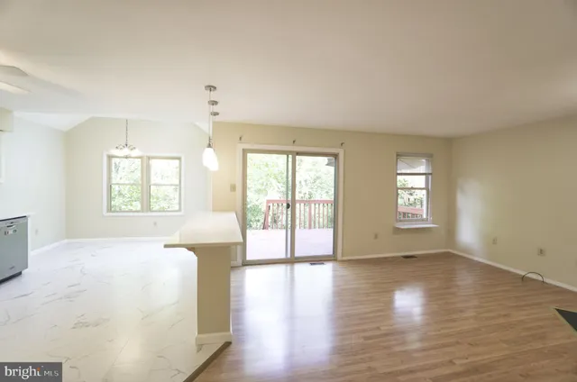 a spacious bedroom with a large bed and wooden floor