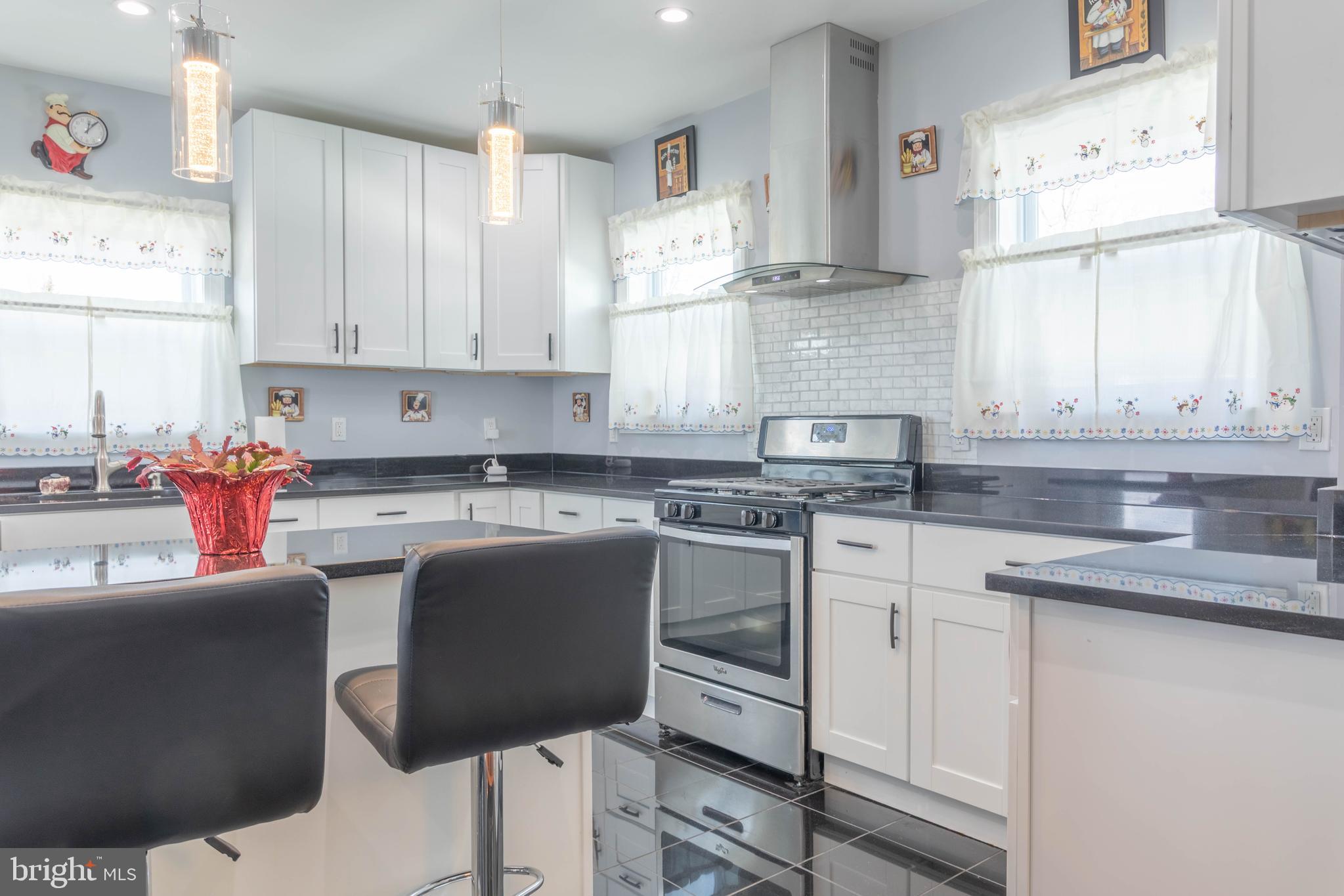 8110 Philadelphia Road Rosedale, MD 21237 - Photo 11 of 28 a kitchen with stainless steel appliances granite countertop a sink stove and cabinets