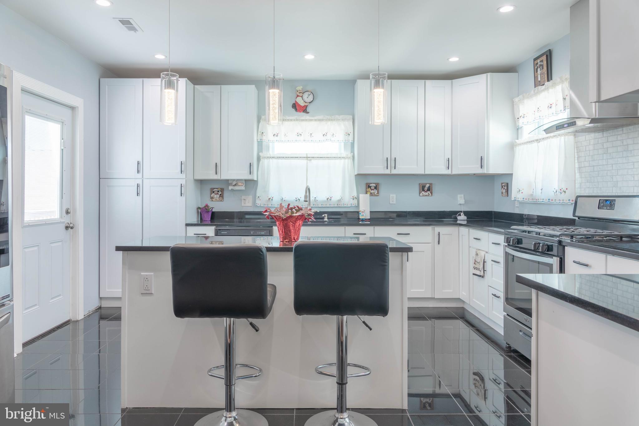 8110 Philadelphia Road Rosedale, MD 21237 - Photo 9 of 28 a kitchen with stainless steel appliances kitchen island granite countertop a sink and cabinets