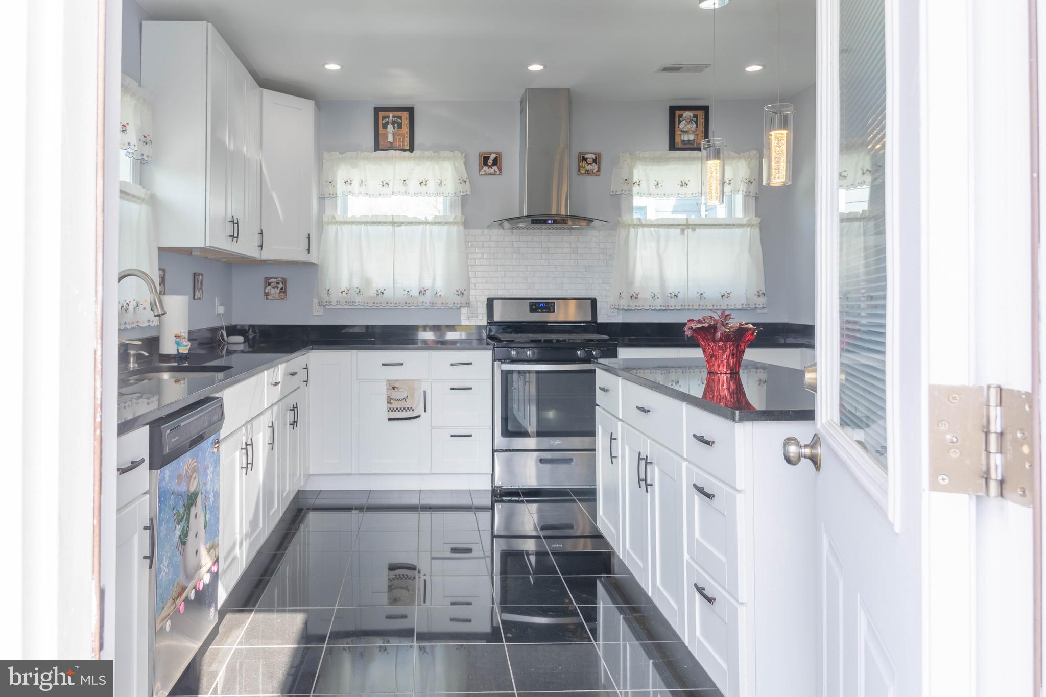 8110 Philadelphia Road Rosedale, MD 21237 - Photo 10 of 28 a kitchen with stainless steel appliances granite countertop a stove and a sink
