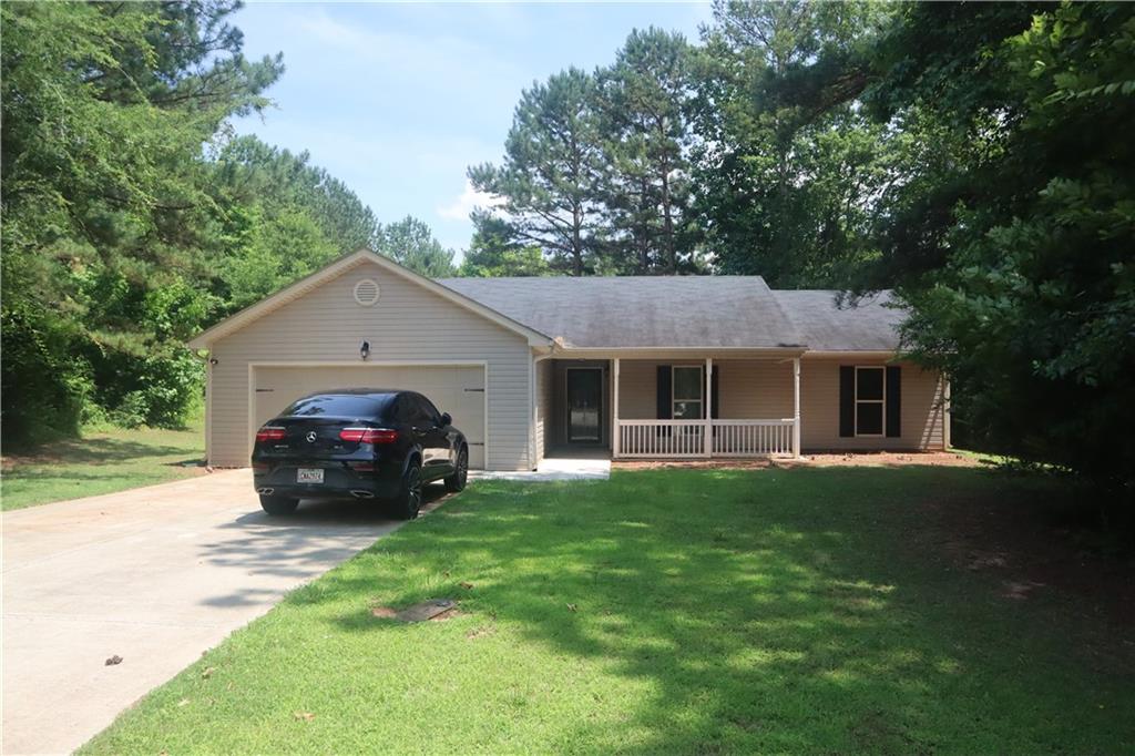482 Raider Way Bethlehem, GA 30620 - Photo 1 of 1 a view of house in front of a big yard with large trees