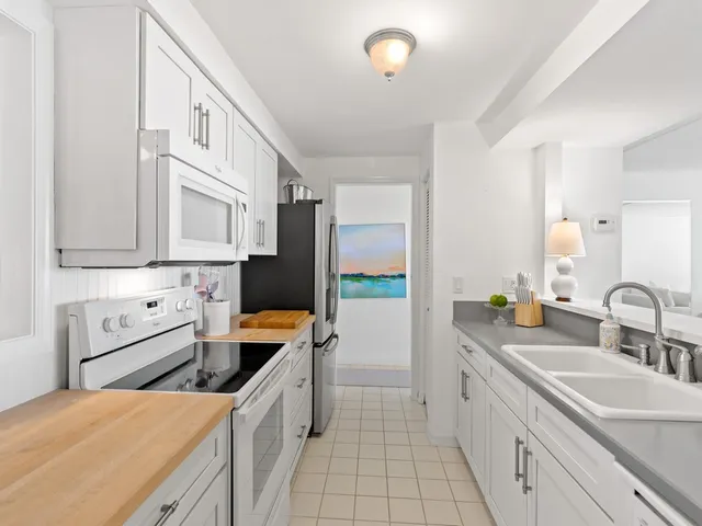 a kitchen with stainless steel appliances a stove a sink and a refrigerator