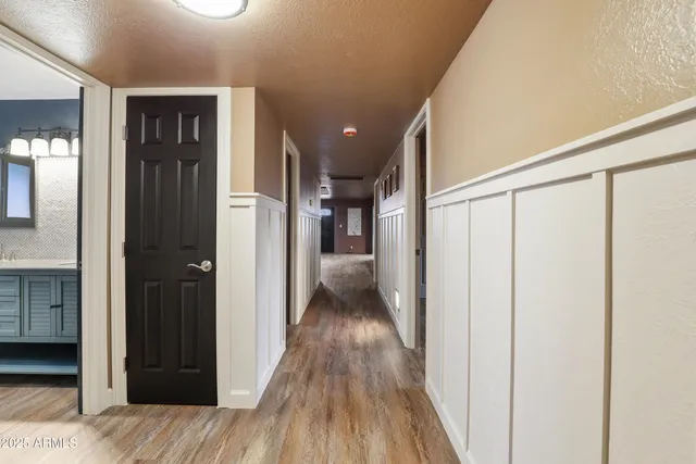 a view of hallway with wooden floor