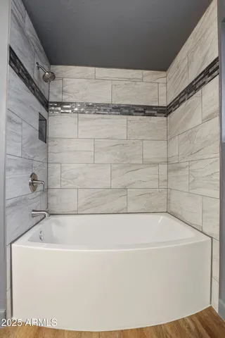 a bathroom with a bathtub and shower