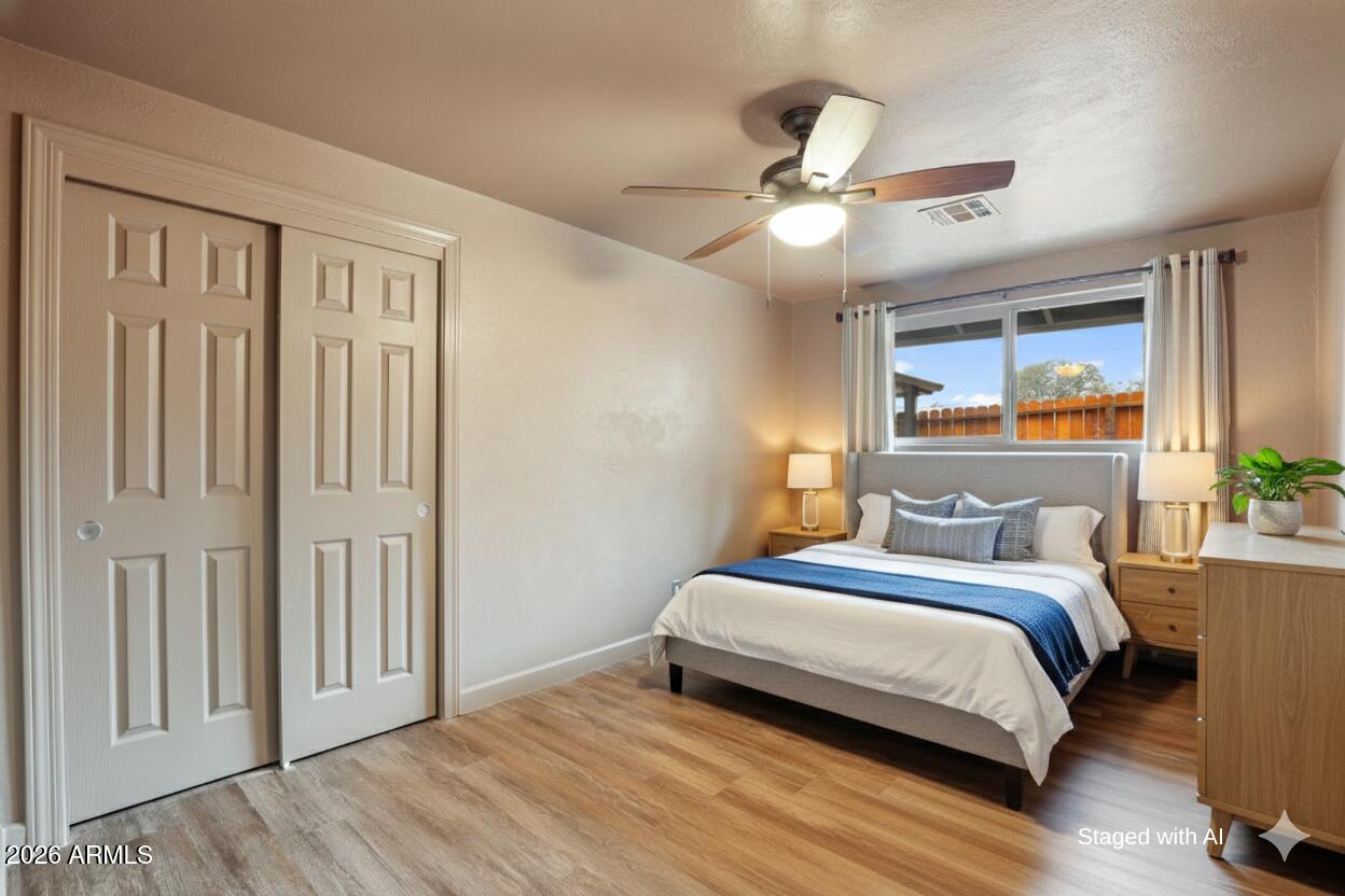 404 West Frontier Street Payson, AZ 85541 - Photo 23 of 39 a bedroom with a bed and a chandelier