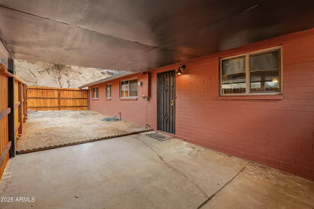 a view of backyard with wooden fence