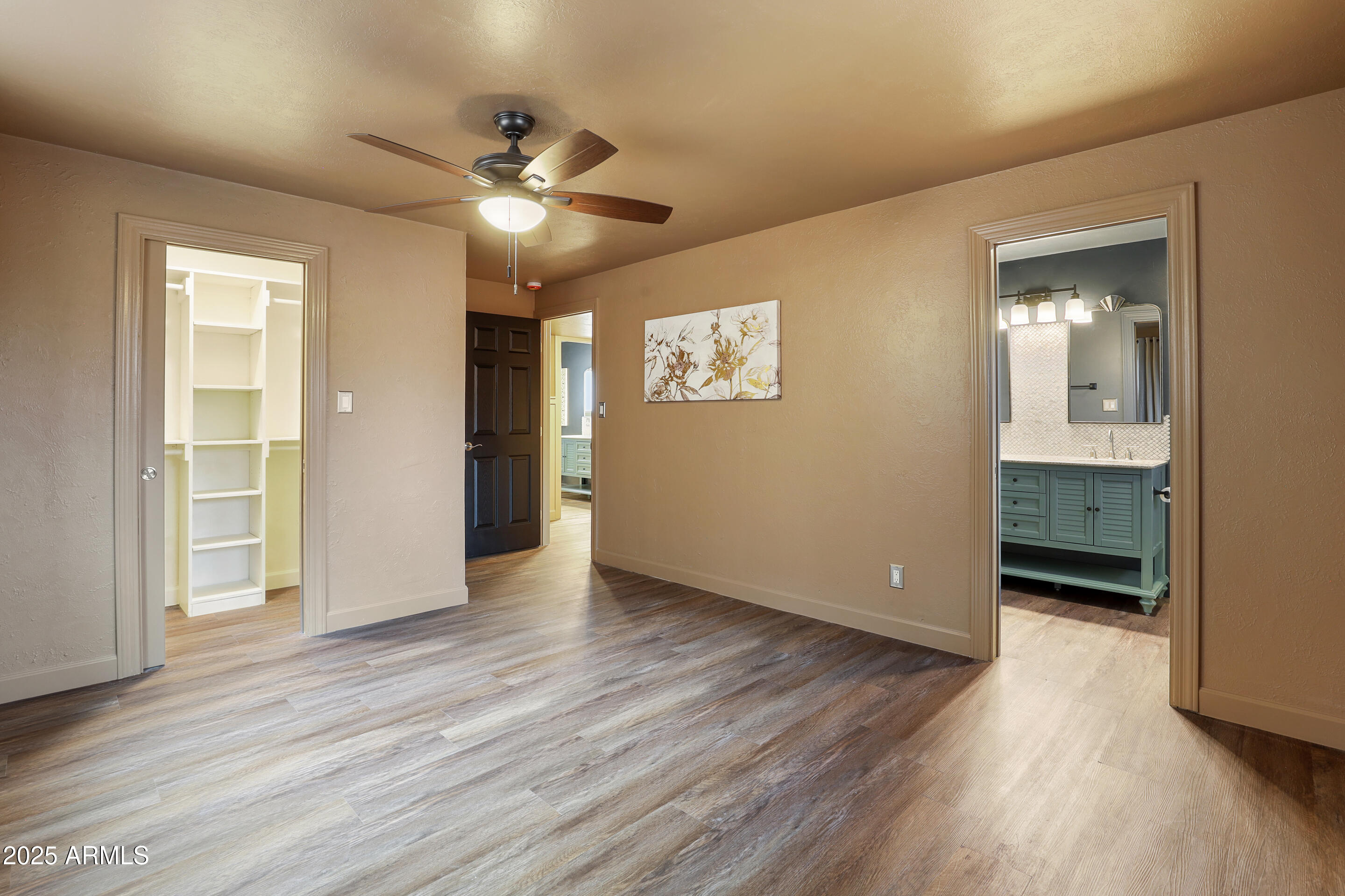 404 West Frontier Street Payson, AZ 85541 - Photo 29 of 39 a view of an empty room with wooden floor and a ceiling fan