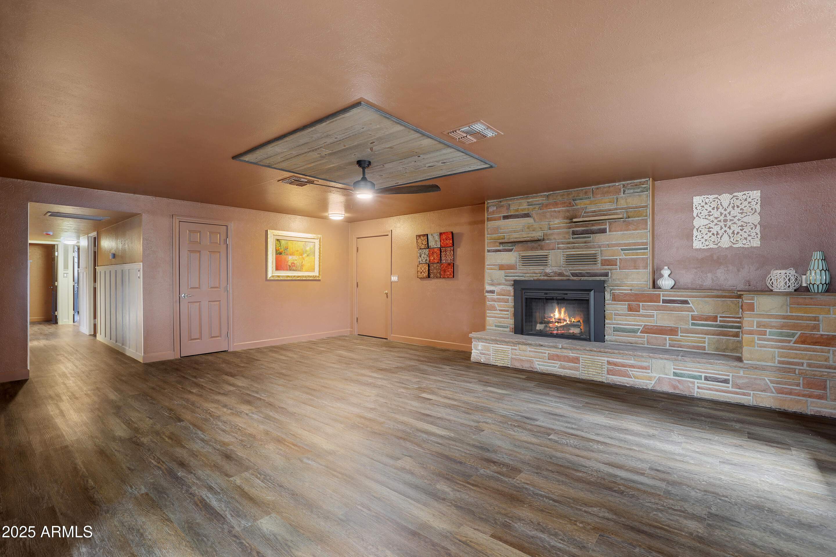 404 West Frontier Street Payson, AZ 85541 - Photo 8 of 39 an empty room with wooden floor fireplace and windows