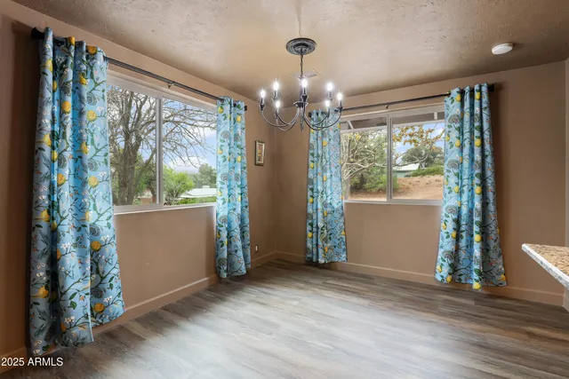 a view of a room with window wooden floor and front door