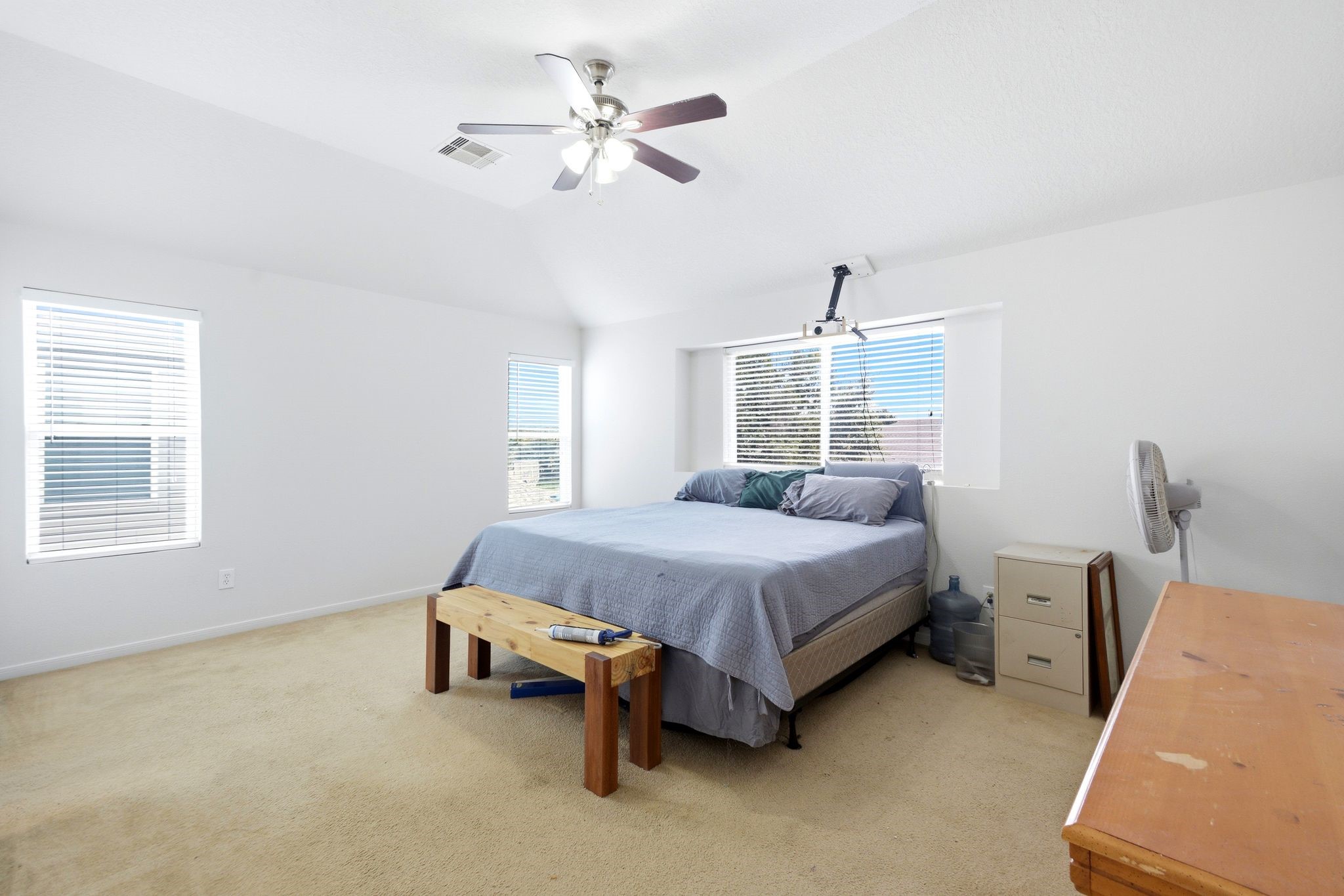 16954 Tableland Trail Conroe, TX 77385 - Photo 21 of 33 Expansive primary suite featuring vaulted ceilings, abundant natural light, neutral finishes, and ample space for a sitting area or home office. A comfortable retreat with direct access to the en-suite bath.