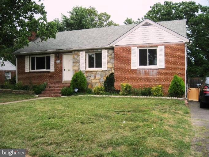 a aerial view of a house next to a yard
