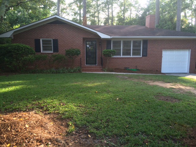 1720 Upper River Road, Unit 2 Macon, GA 31211 - Photo 1 of 8 a backyard of a house with plants and large tree