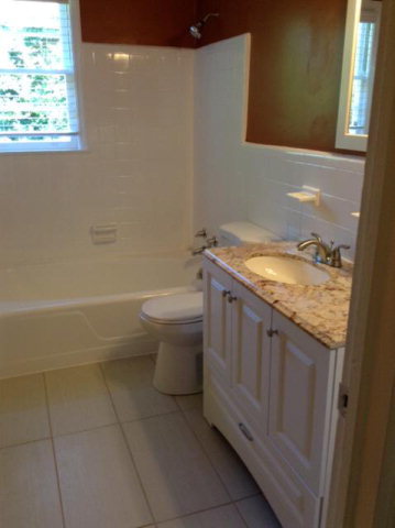 1720 Upper River Road, Unit 2 Macon, GA 31211 - Photo 2 of 8 a bathroom with a granite countertop sink a toilet and a bathtub