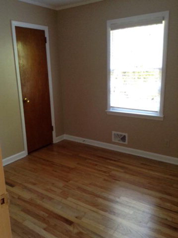 1720 Upper River Road, Unit 2 Macon, GA 31211 - Photo 8 of 8 an empty room with wooden floor and windows