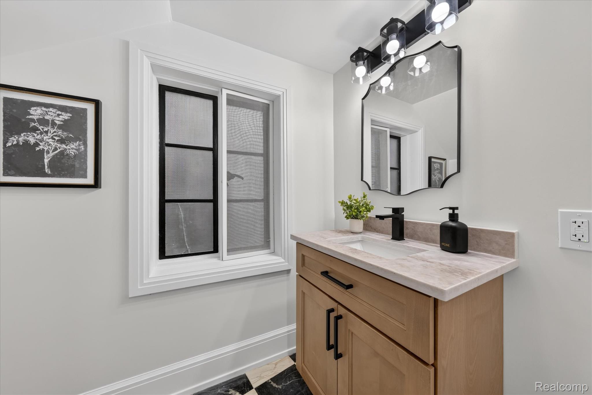3250 Sherbourne Road Detroit, MI 48221 - Photo 10 of 36 Wood-finish vanity with a rectangular undermount sink, light-toned countertop, and matte black faucet