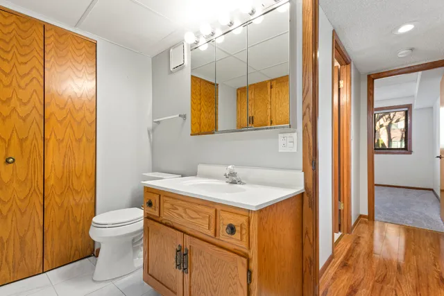 a bathroom with a sink a toilet and a mirror