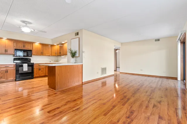 a view of kitchen view wooden floor and electronic appliances
