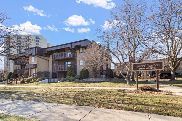 a view of a house with snow on the side of the road