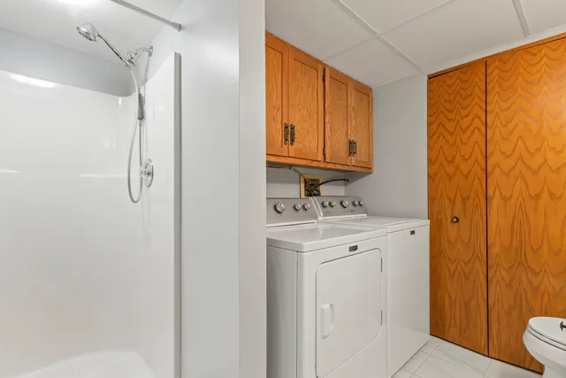 a bathroom with a granite countertop sink a toilet and shower