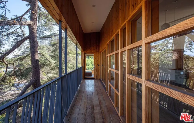 a view of a room with wooden floor and door