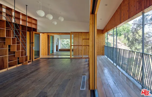 a view of hallway with wooden floor and stairs