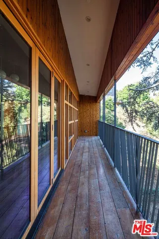 a view of a balcony with wooden floor