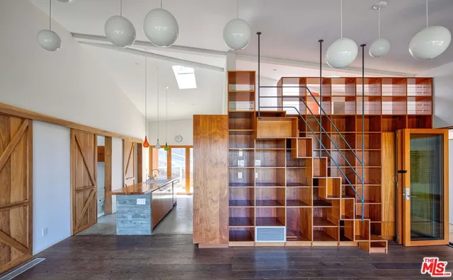 a kitchen with a stove a refrigerator and a window