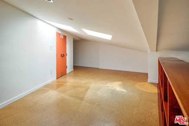 a view of a house with a tree next to a yard