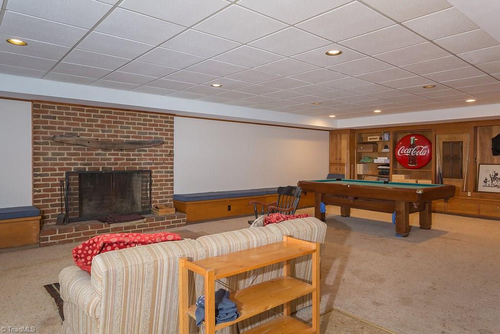 2206 Red Forest Road Greensboro, NC 27410 - Photo 23 of 30 Large fireplace for you to enjoy downstairs. Did we mention the additional bedroom/office, full bath and storage room that is also in the basement?