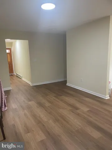 an empty room with windows and entrance