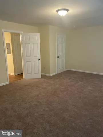 a view of an empty room and a window