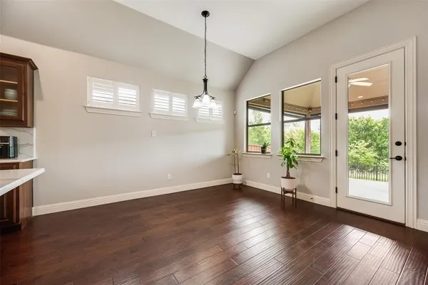 a view of a kitchen with microwave and wooden floor