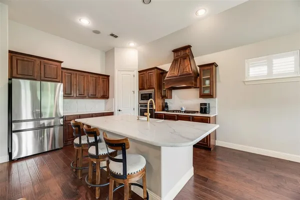 a kitchen with a stove a sink and a refrigerator