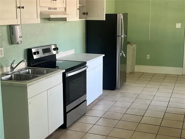 a kitchen with cabinets and appliances