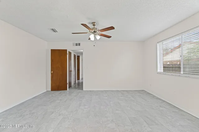a view of an empty room with a window