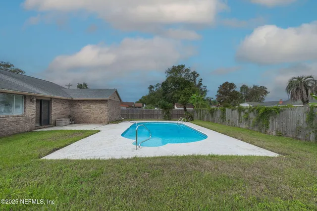 an aerial view of a house with a big yard