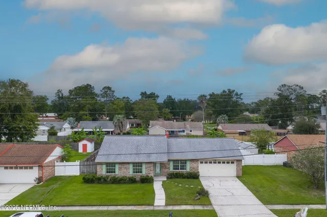 an aerial view of a house with a swimming pool