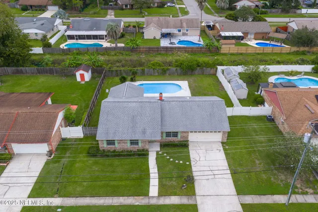 an aerial view of a house with a garden and trees