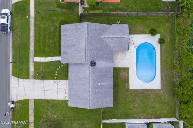 an aerial view of a house with garden space and street view