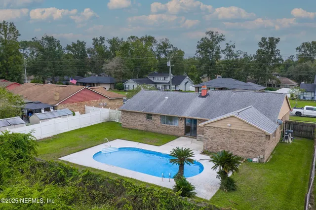 a view of white house with a yard