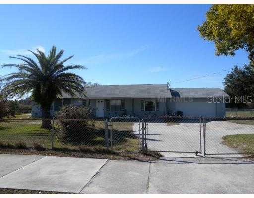 2094 Neptune Road Kissimmee, FL 34744 - Photo 1 of 1 a palm tree sitting in front of a house with a yard
