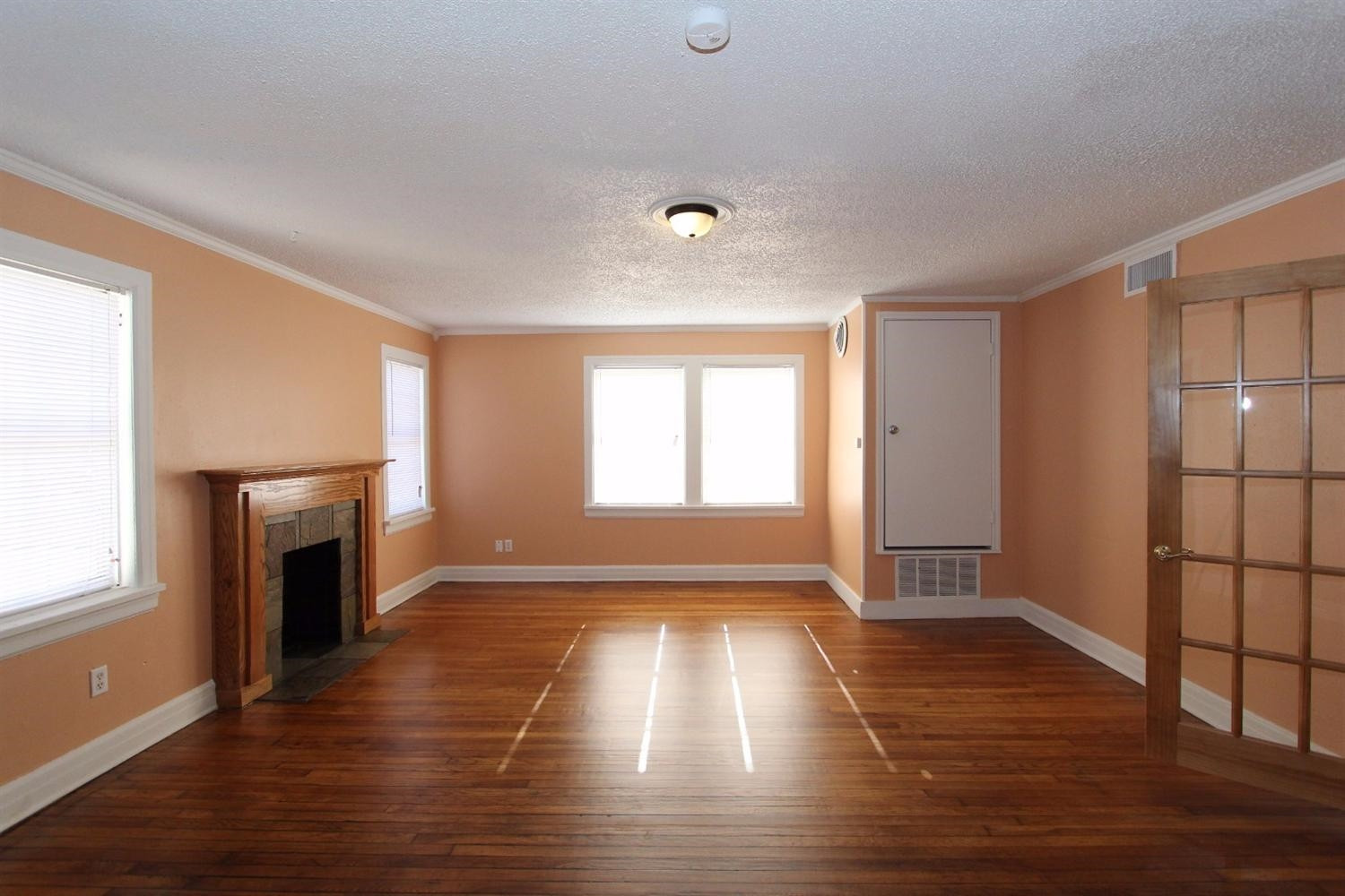 2203 20th Street Lubbock, TX 79411 - Photo 3 of 10 a view of empty room with wooden floor and fireplace