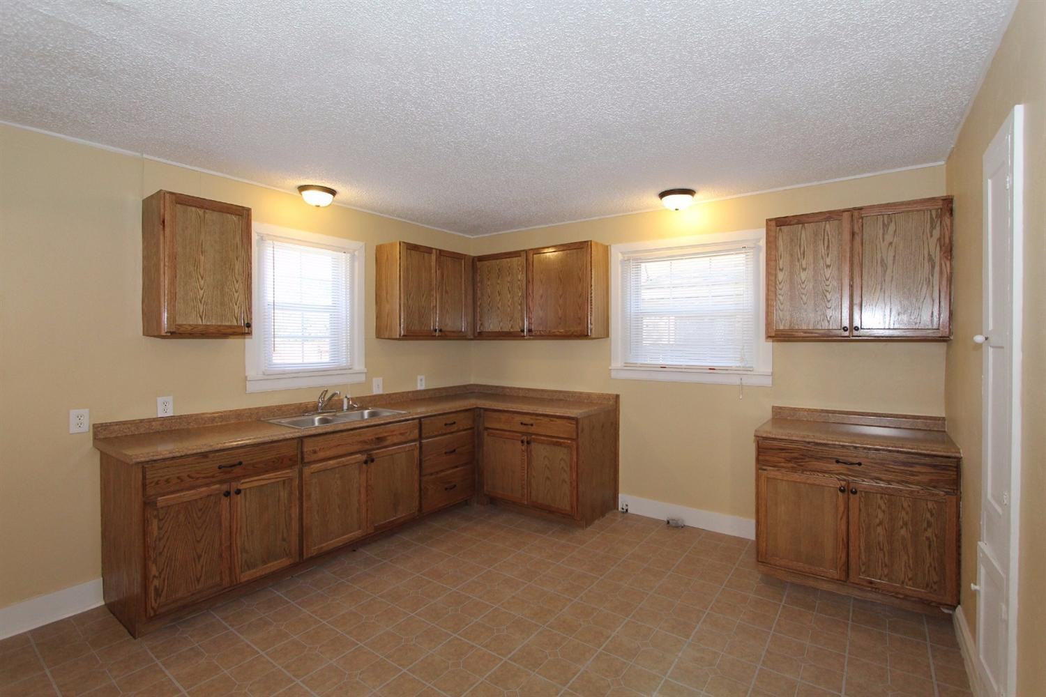 2203 20th Street Lubbock, TX 79411 - Photo 4 of 10 a kitchen with sink cabinets and window