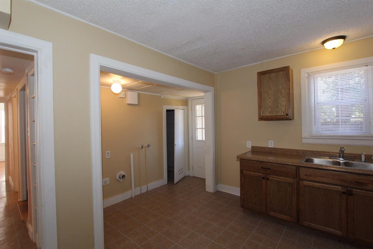 2203 20th Street Lubbock, TX 79411 - Photo 5 of 10 a kitchen with a sink and cabinets