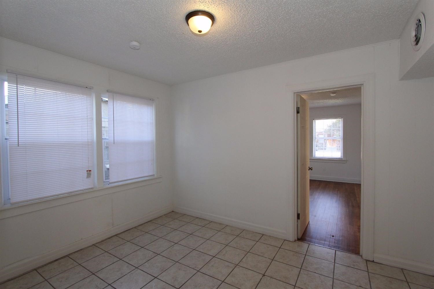 2203 20th Street Lubbock, TX 79411 - Photo 7 of 10 an empty room with a empty space and windows