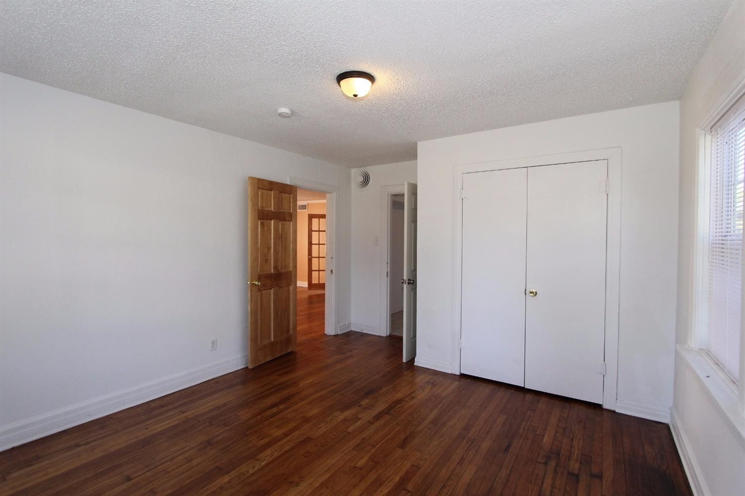 2203 20th Street Lubbock, TX 79411 - Photo 10 of 10 a view of an empty room with wooden floor and closet