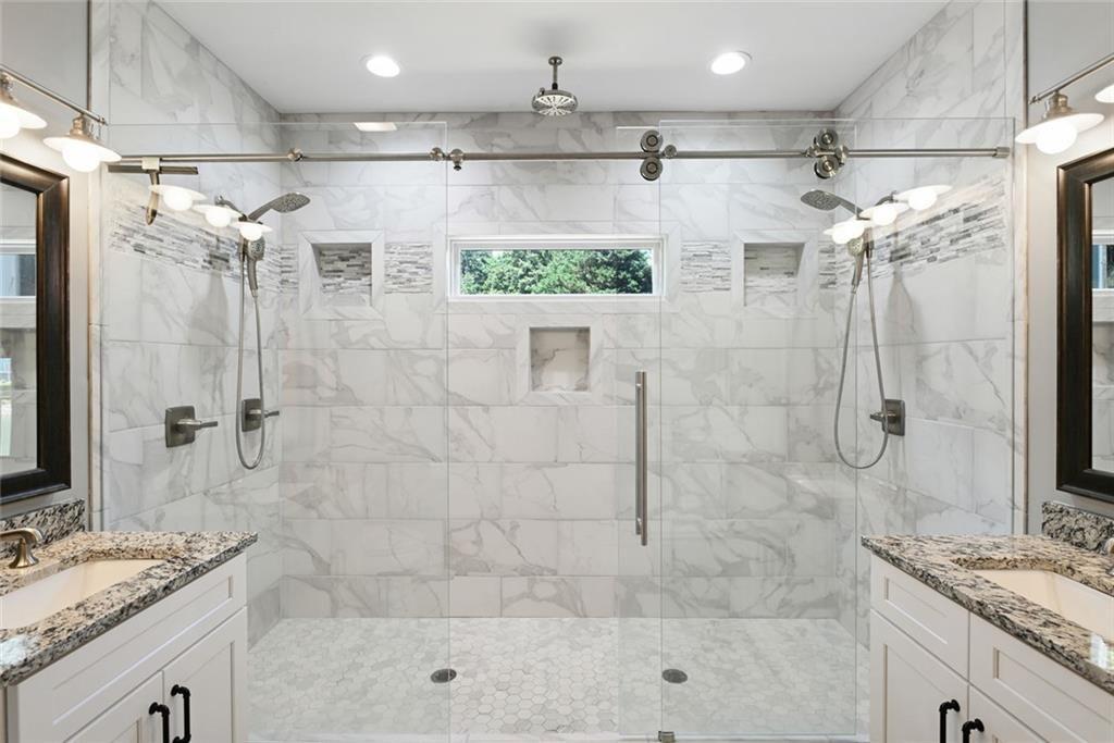2040 Ridge Road Cumming, GA 30041 - Photo 26 of 52 a bathroom with a granite countertop sink a shower and a mirror