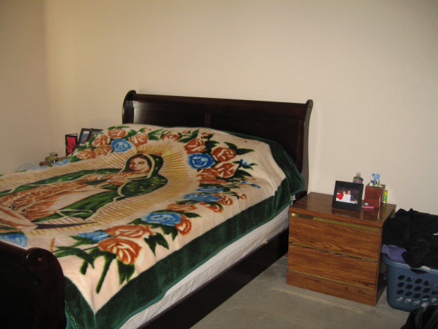 14203 Overpass Road Watsonville, CA 95076 - Photo 5 of 9 a bed sitting in a bedroom next to a window with dresser