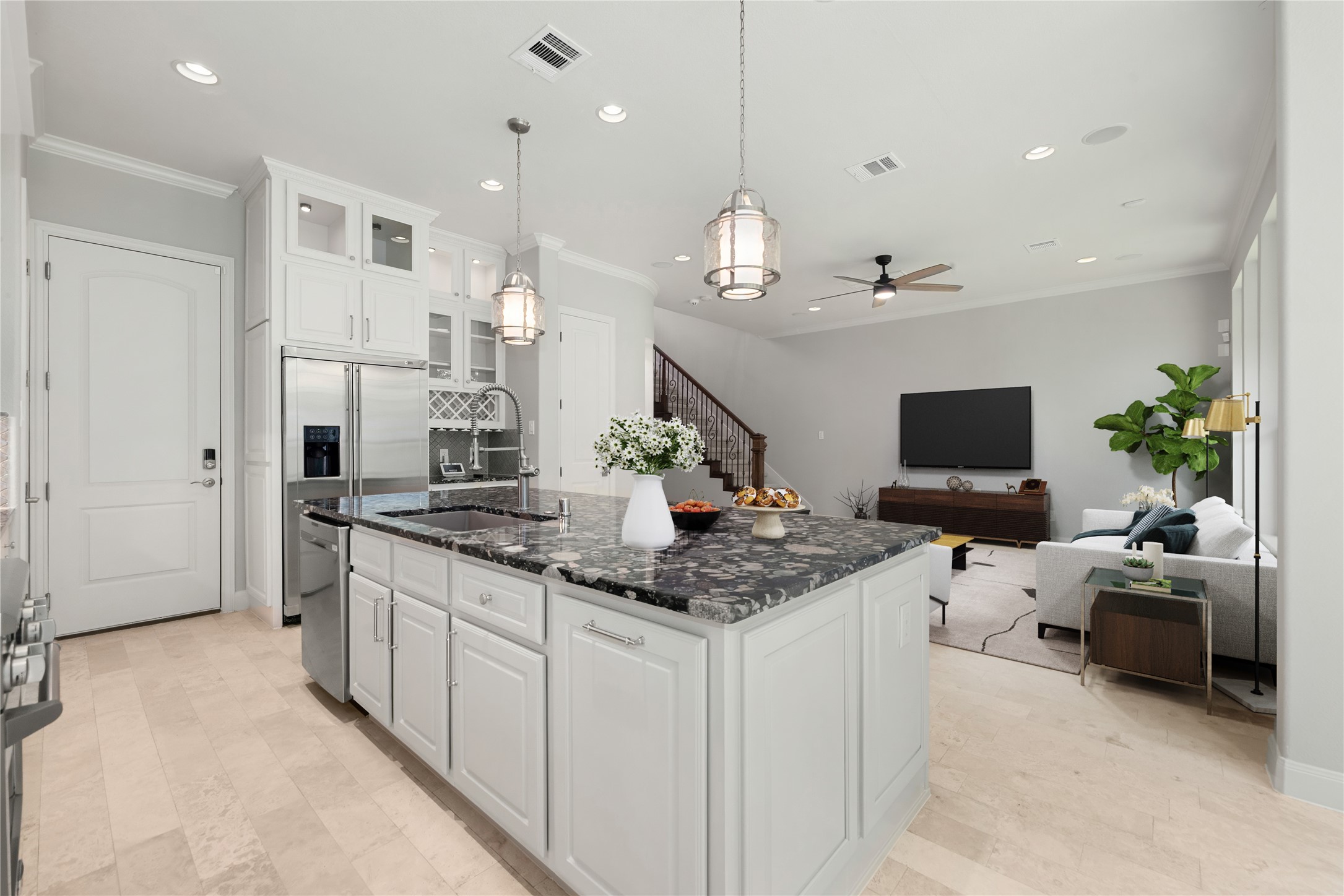 98 Herons Flight Place Spring, TX 77389 - Photo 10 of 29 Open-concept kitchen overlooks the living area, ideal for entertaining, with granite island, stainless sink, and dishwasher. *Virtually Staged